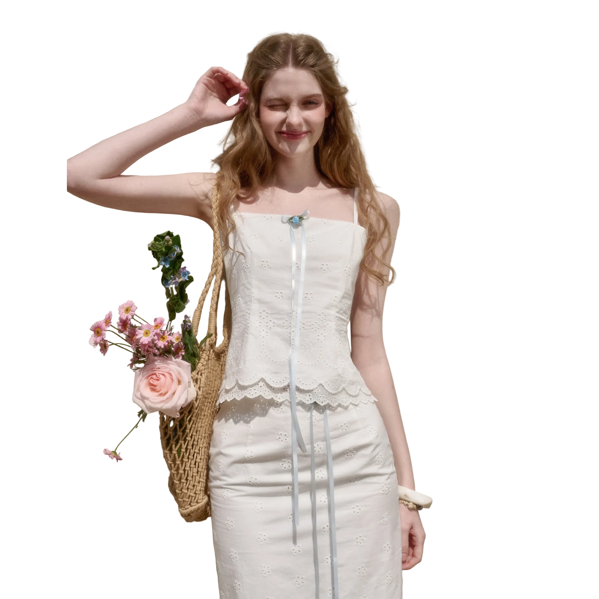 Woman in a white dress holding flowers against a beige wall